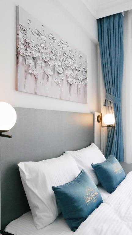 Postel nebo postele na pokoji v ubytování Nefis Hotel City
