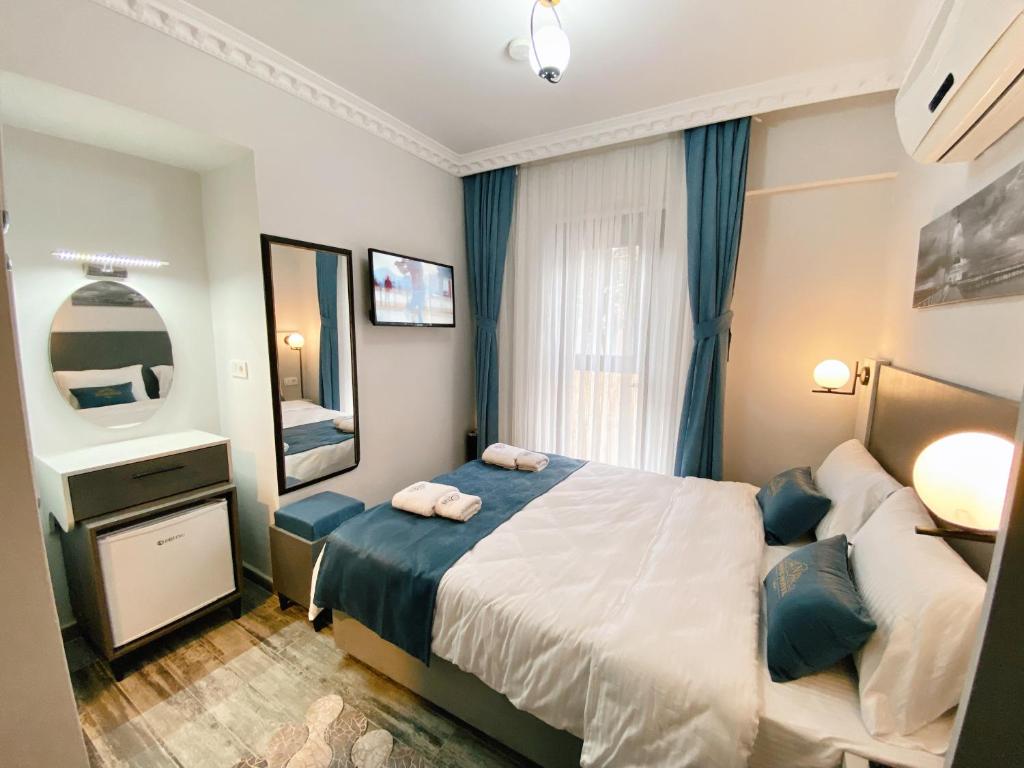 Postel nebo postele na pokoji v ubytování Nefis Hotel City