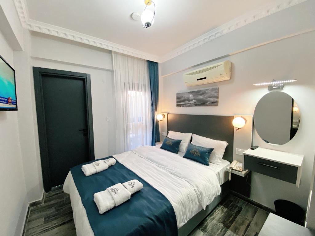 Postel nebo postele na pokoji v ubytování Nefis Hotel City