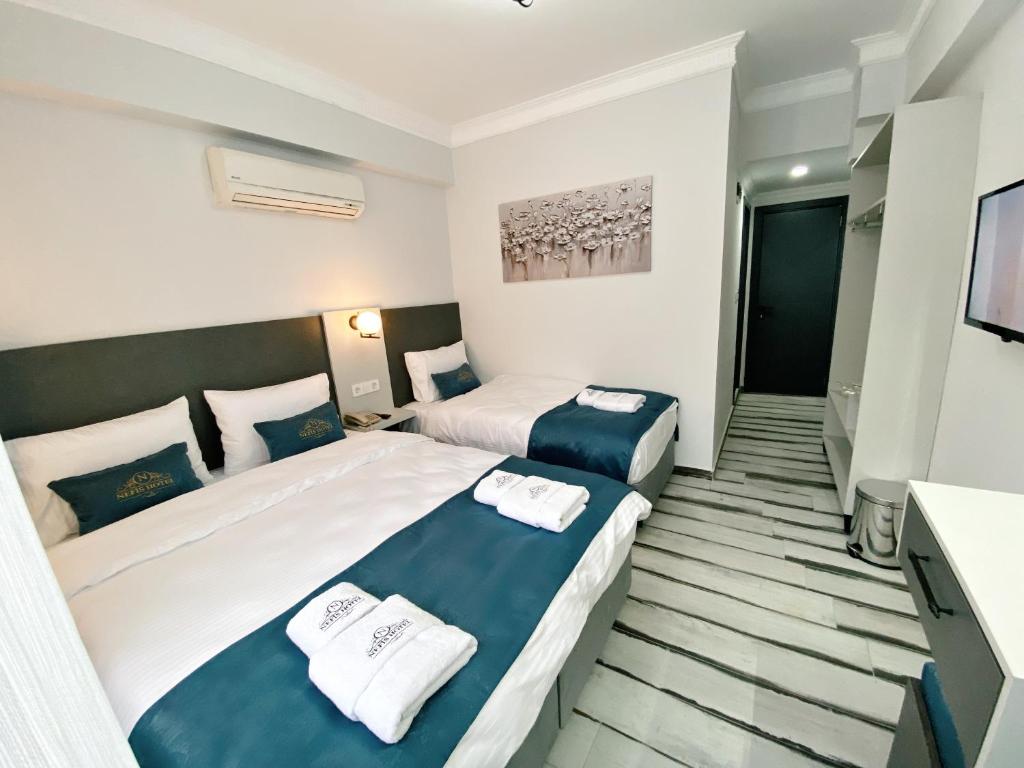 Postel nebo postele na pokoji v ubytování Nefis Hotel City