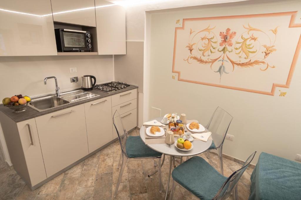 a small kitchen with a table with food on it at Brunelli Appartamenti in Assisi