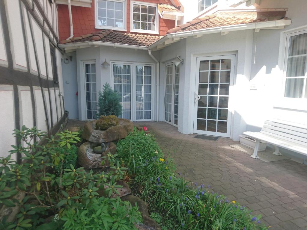 a porch of a white house with a bench at Landhaus Studio in D 63667 Nidda, Gäßchen 8 Erdgeschoss links in Nidda