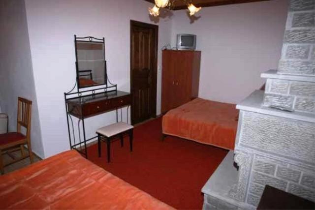 A bed or beds in a room at Terpsichori Guesthouse