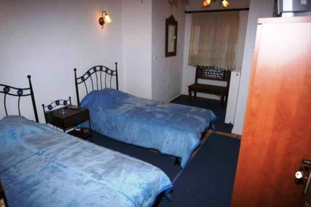A bed or beds in a room at Terpsichori Guesthouse