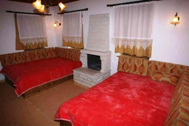 A bed or beds in a room at Terpsichori Guesthouse