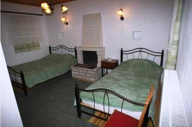 A bed or beds in a room at Terpsichori Guesthouse