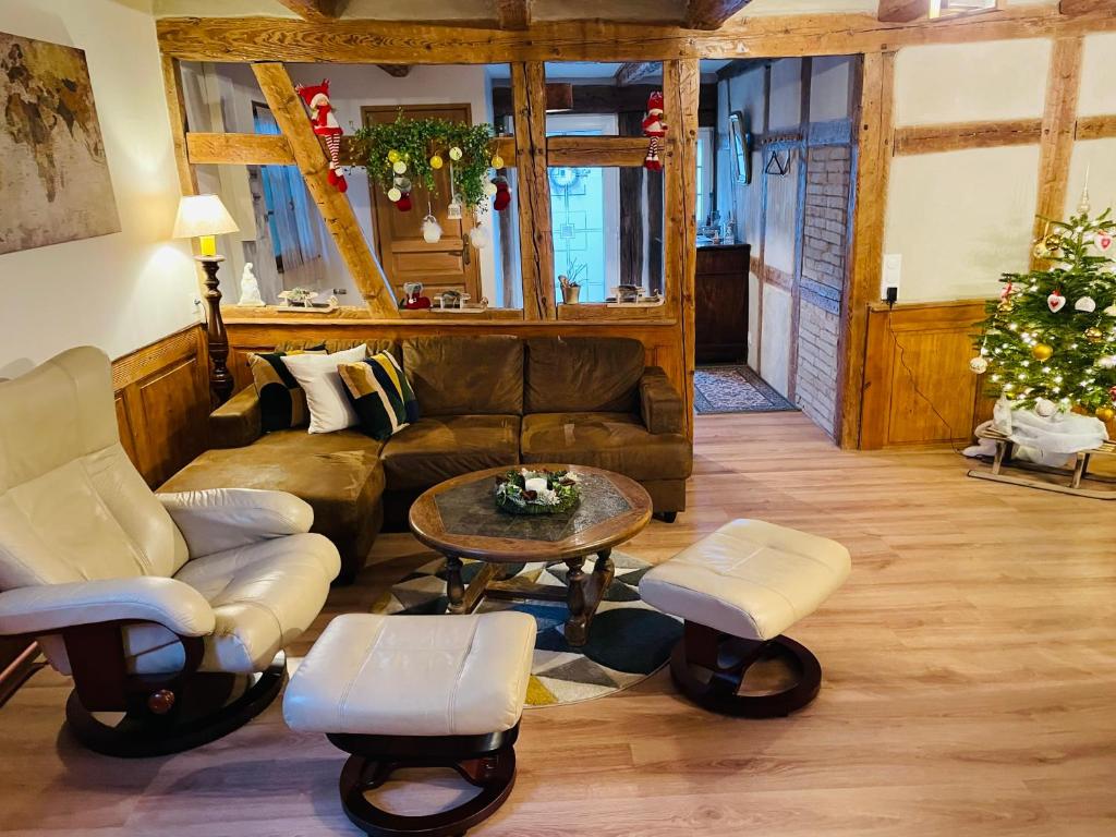 a living room with a couch and a table at La Ferme de Madeleine in Fessenheim-le-Bas