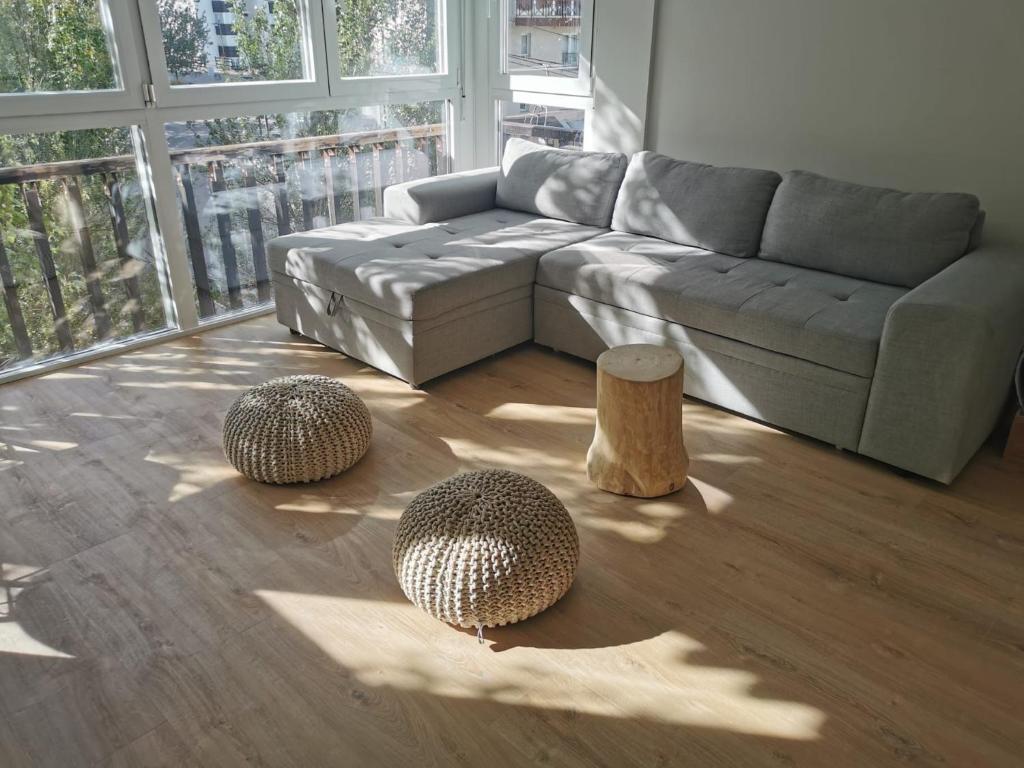 a living room with a couch and two stump tables at Apartamentos Bluettravel Parador 1 in Sierra Nevada