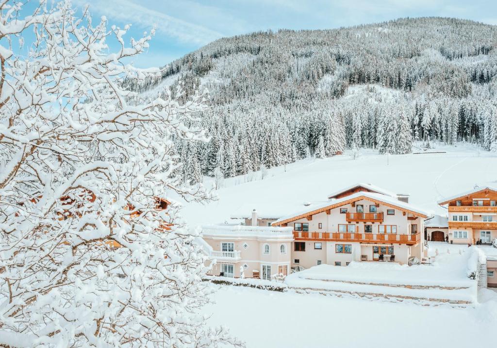 a town covered in snow with mountains in the background at Gästehaus Eder in Sankt Martin am Tennengebirge