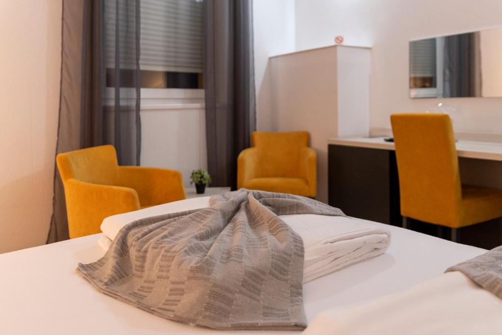 Postel nebo postele na pokoji v ubytování Garni Hotel 11tica DM