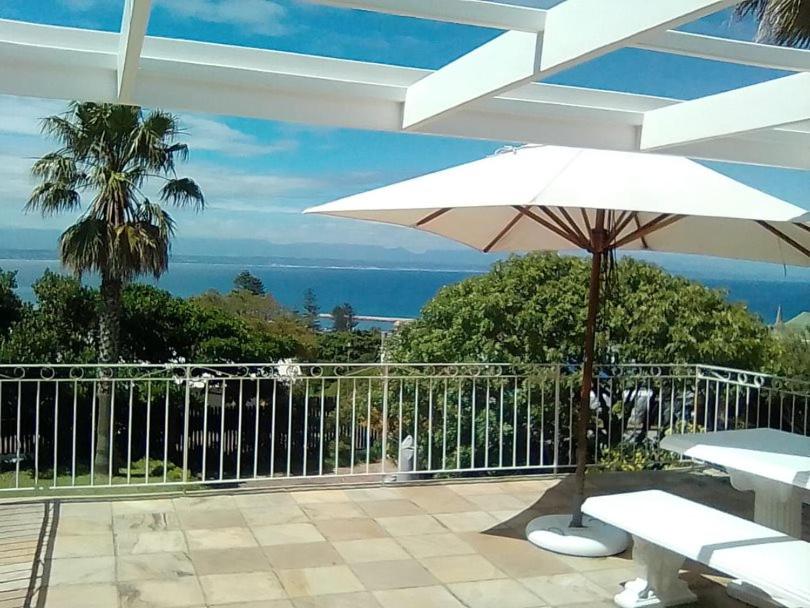 a white umbrella sitting on top of a patio at 4 Duke Street Flat#3 in Mossel Bay