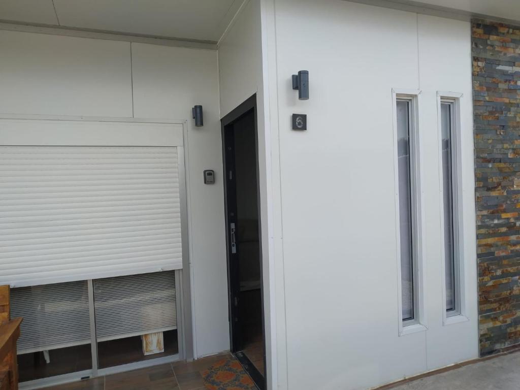 a garage door with a window next to a brick wall at Casita de Piedra 6 in Trinidad