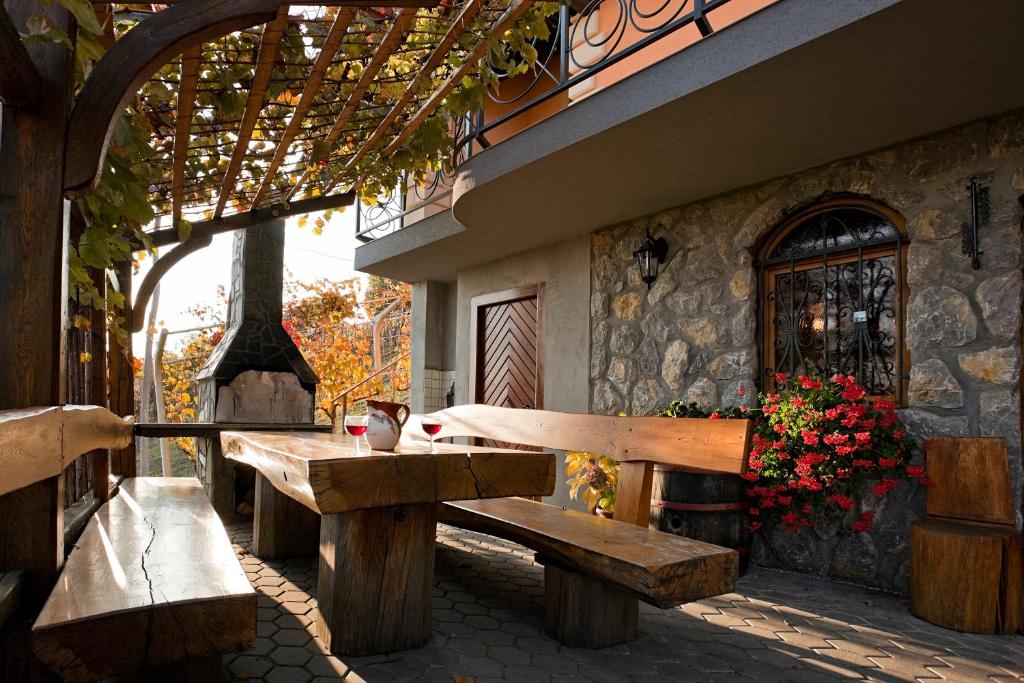 a wooden bench sitting outside of a building at Vineyard Cottage Bregac in Smarjeske Toplice