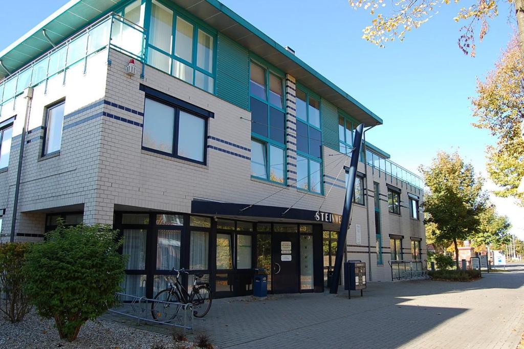 a building with a bike parked in front of it at Apartment am Steinweg in Emden