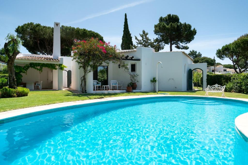 una villa con piscina frente a una casa en Villa Serendipity by SAPvillas, en Vilamoura