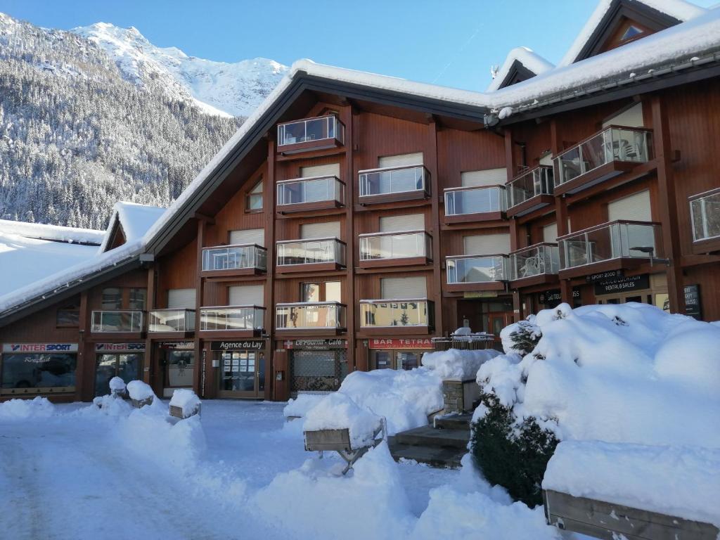 a building with snow in front of it at Studio Les Contamines Montjoie - Les Combettes - Le Lay - WIFI INCLUS in Les Contamines-Montjoie