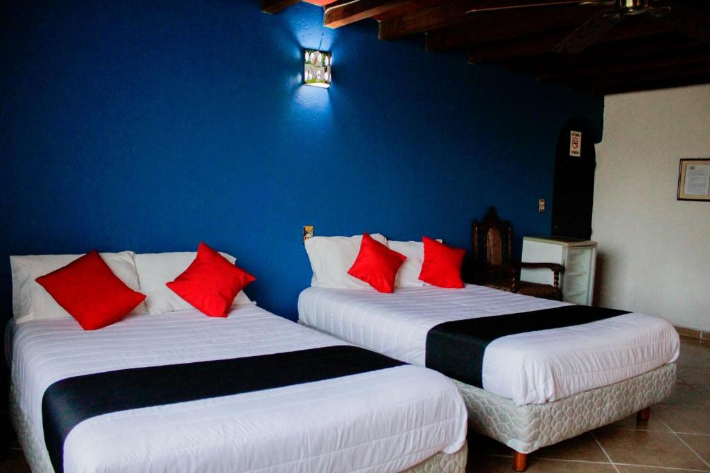 Postel nebo postele na pokoji v ubytování Hotel Boutique Don Porfirio
