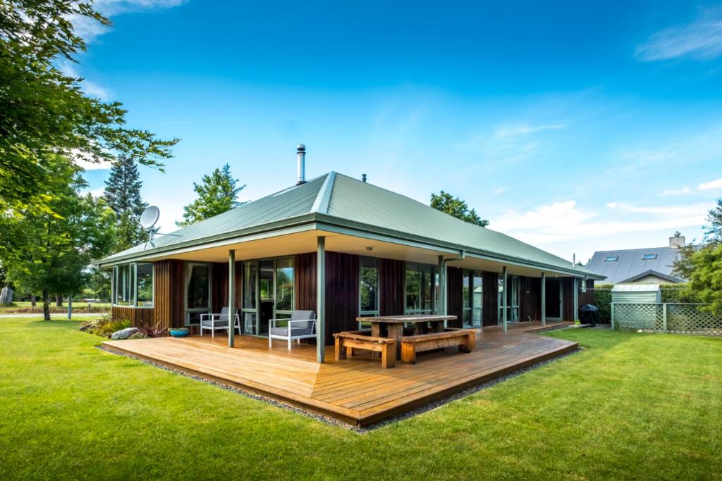 a house with a wooden deck in a yard at 58 Rippingale Road in Hanmer Springs