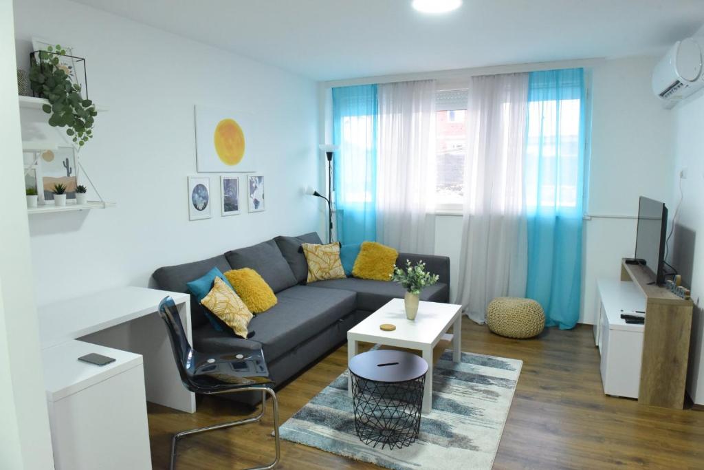 sala de estar con sofá y mesa en Central Apartment, en Ćuprija
