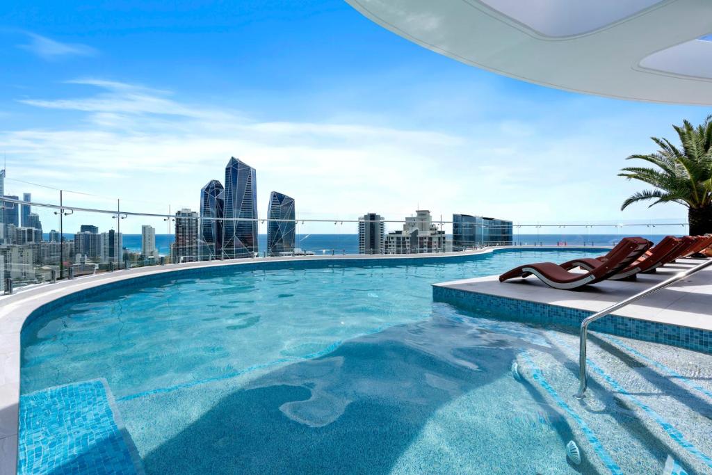 a swimming pool with a view of the city at The Gallery Broadbeach - GCLR in Gold Coast