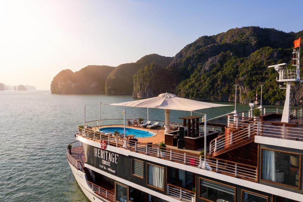 a cruise ship in the water with a pool at Heritage Cruises Binh Chuan Cat Ba Archipelago in Ha Long