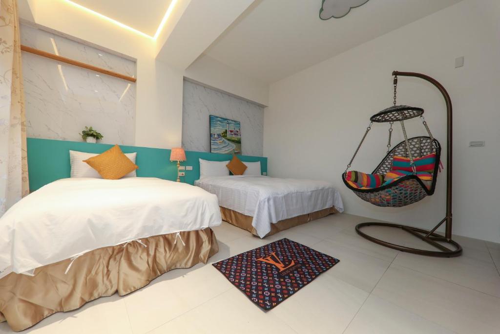 a room with two beds and a hanging swing at Enjoy the Lift in Ch'ing-shui