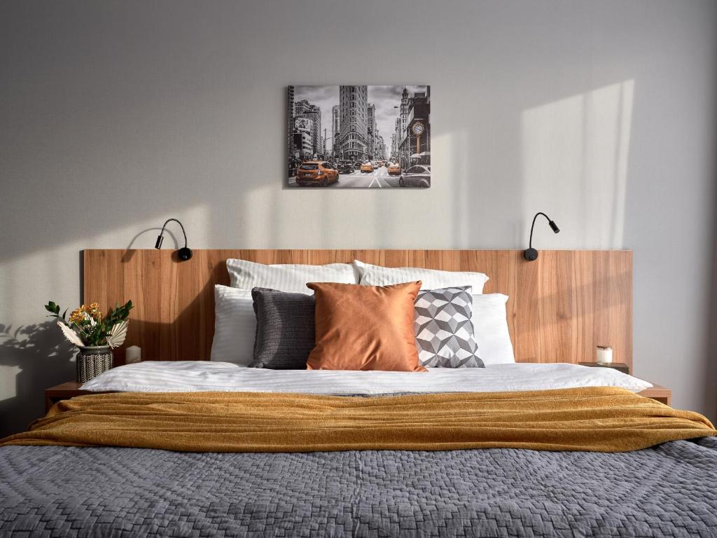 a bedroom with a large bed with a wooden headboard at Студия 15 in Irkutsk