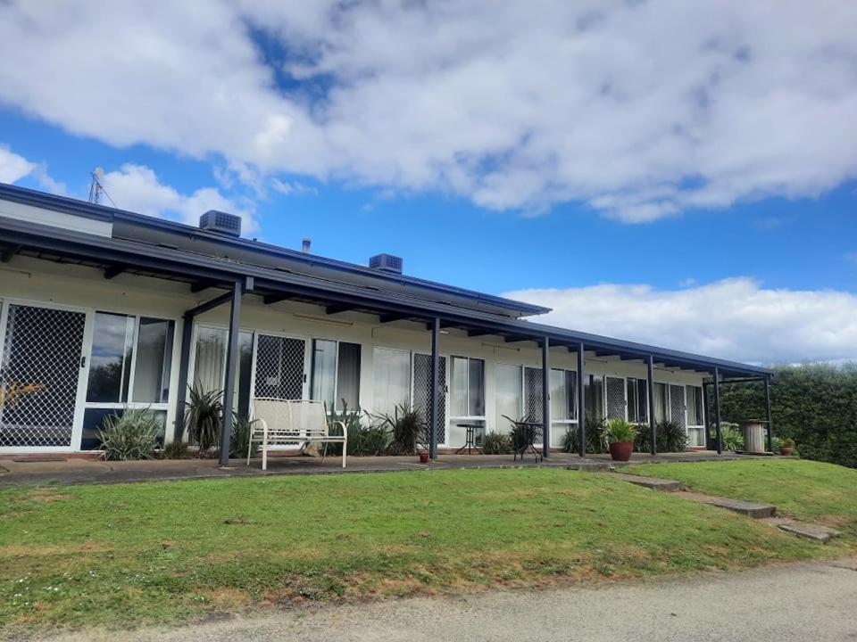 a building with a lawn in front of it at Neerim South Hotel in Neerim South