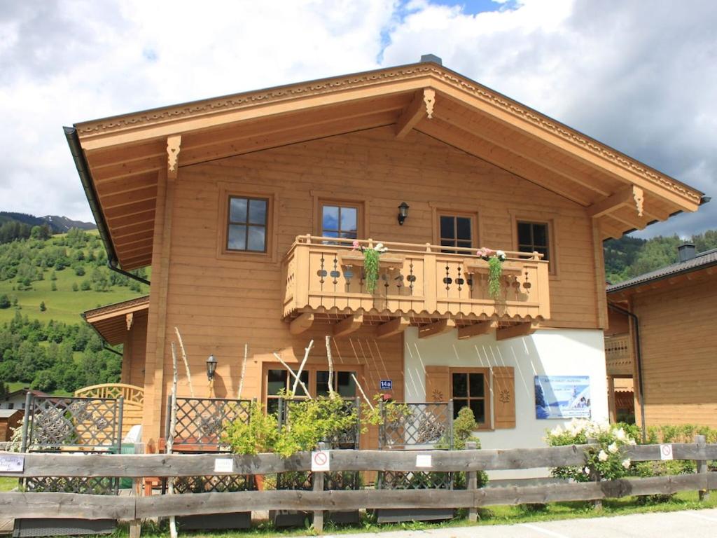 a log home with a balcony on a house at Modern Chalet with Sauna in Niedernsill in Niedernsill