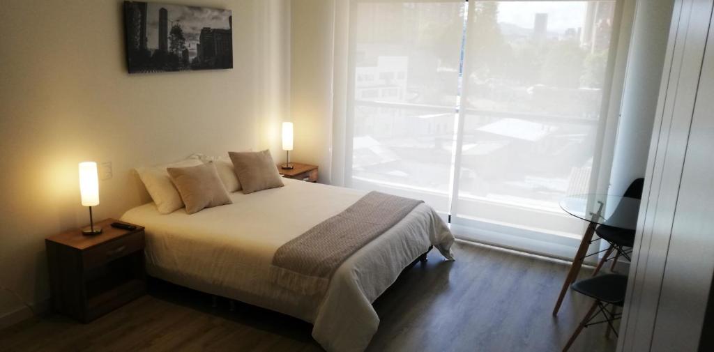 Postelja oz. postelje v sobi nastanitve Acogedor Apartamento en Centro Internacional Bogotá