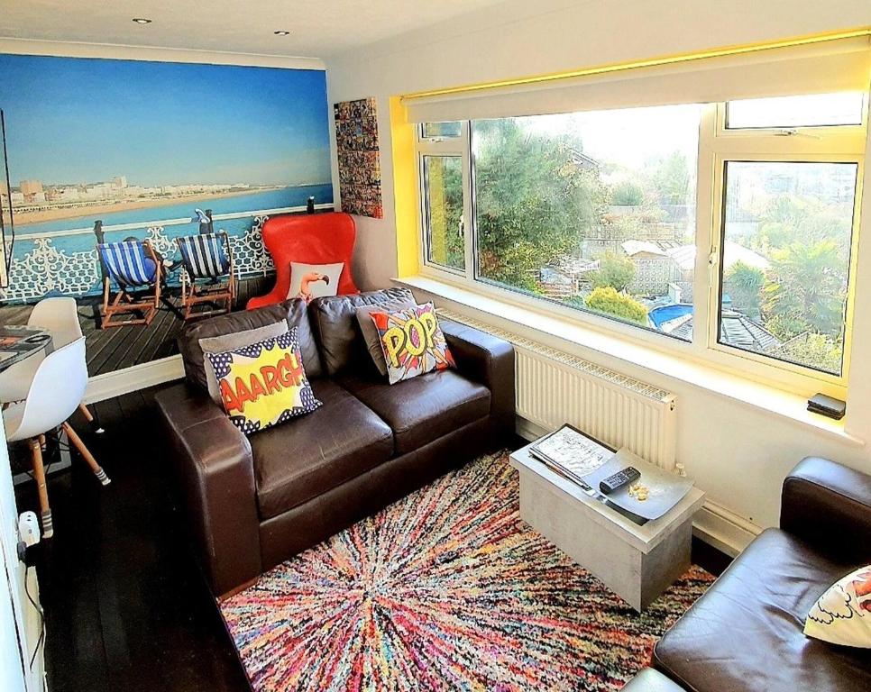 a living room with a couch and a large window at 3 Bed House Stunning Views And Free Parking in Rottingdean