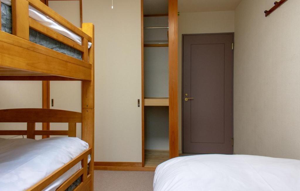 Postel nebo postele na pokoji v ubytování T Square Hakuba