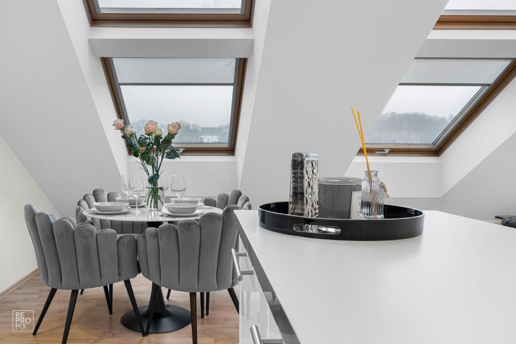 a dining room with a table and chairs at Kaunas Old Town apartment with underground parking in Kaunas