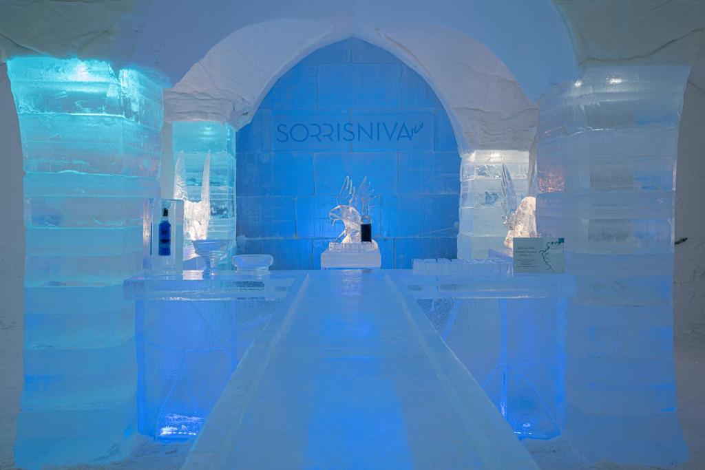 an exhibit of an ice room with blue lights at Sorrisniva Igloo Hotel in Alta