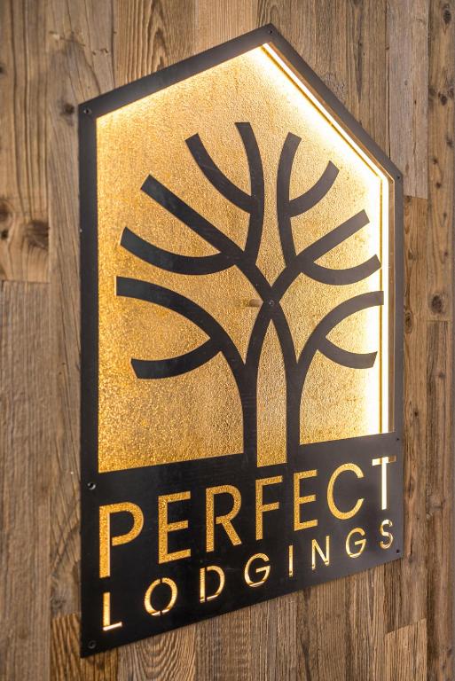 a sign for a perrier lodges on a wooden wall at Perfect Lodgings Panorama in Hart im Zillertal