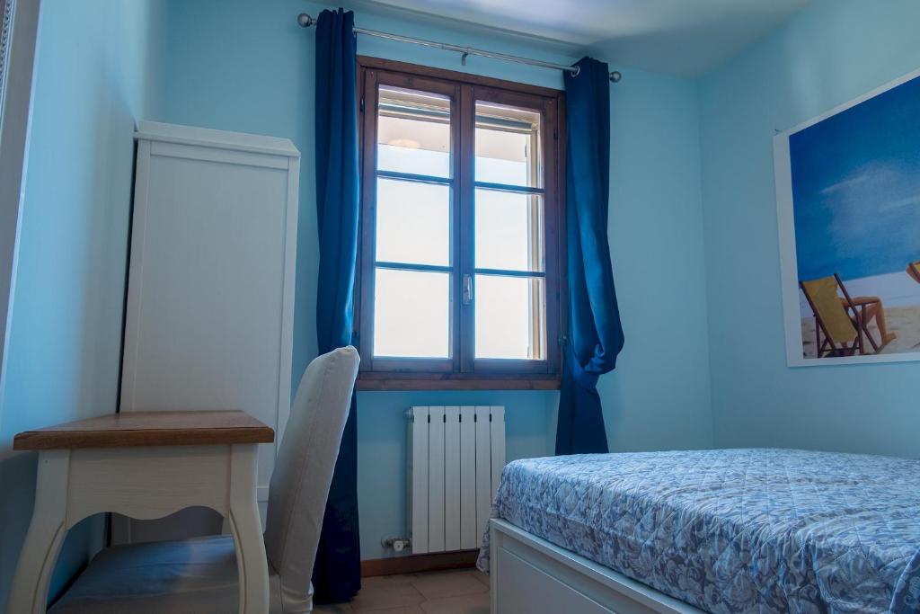 A bed or beds in a room at La Casa Sul Porto - Italian Homing