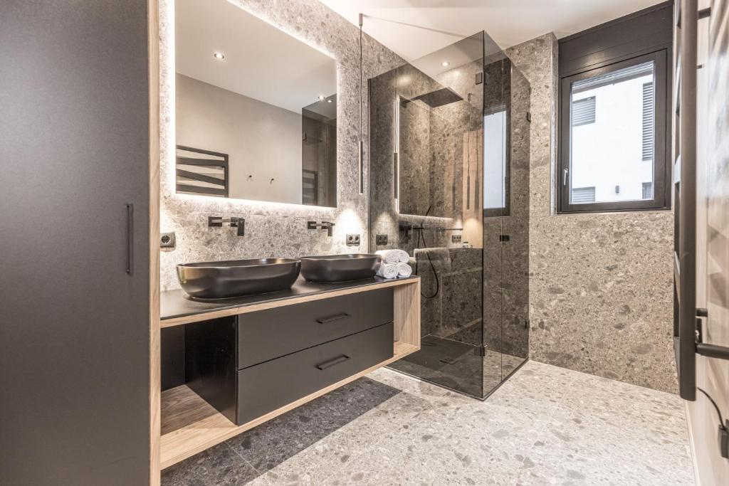 a bathroom with two sinks and a shower at Perfect Lodgings Panorama in Hart im Zillertal