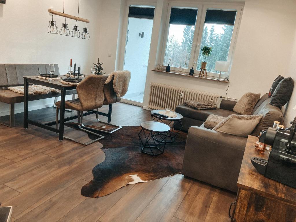 a living room with a couch and a table at Ferienwohnung Paula Winterberg in Winterberg