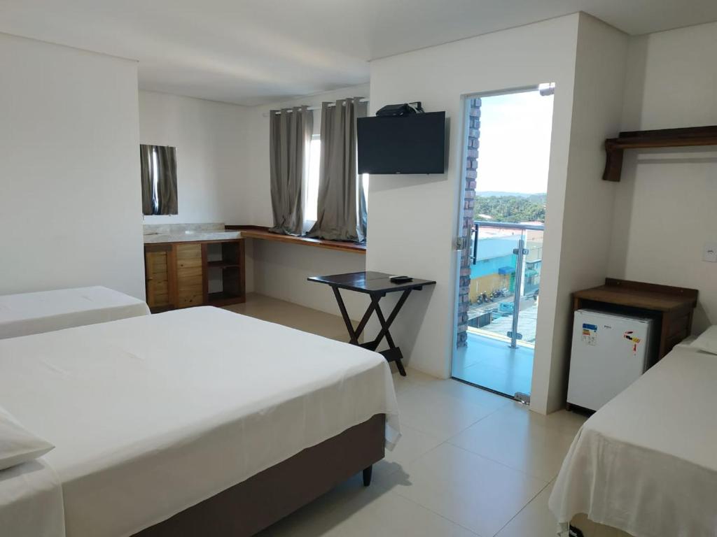 Hotel Lírio tesisinde bir odada yatak veya yataklar