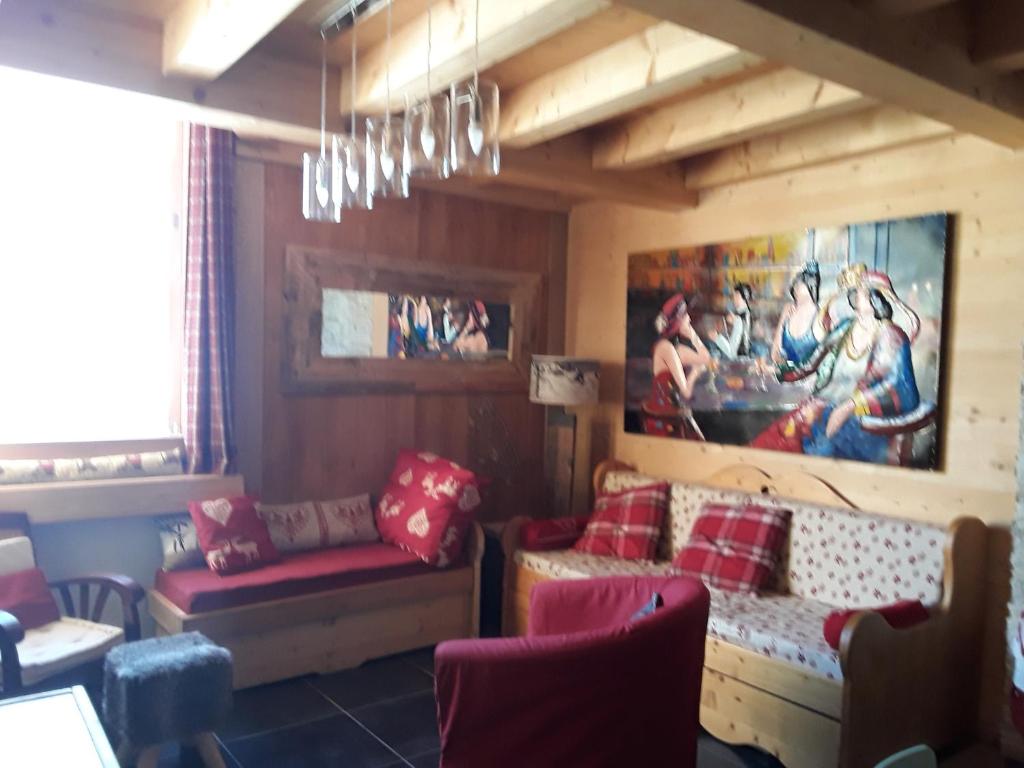 a living room with a couch and a painting on the wall at La Courtine 3 in Verchaix