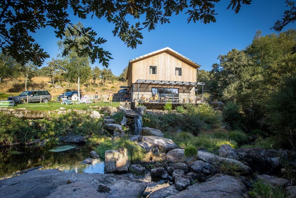 a house on a hill next to a river at Casa do Moinho in Montalegre