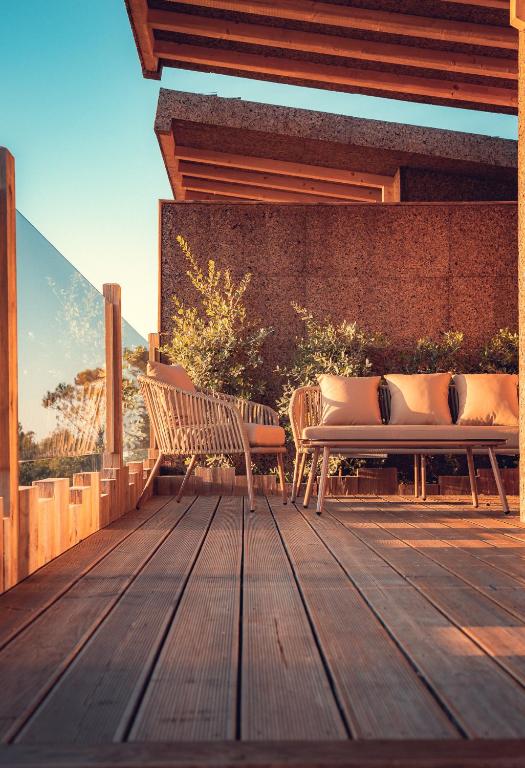 two benches sitting on a wooden deck at Charm Nature in Azoia