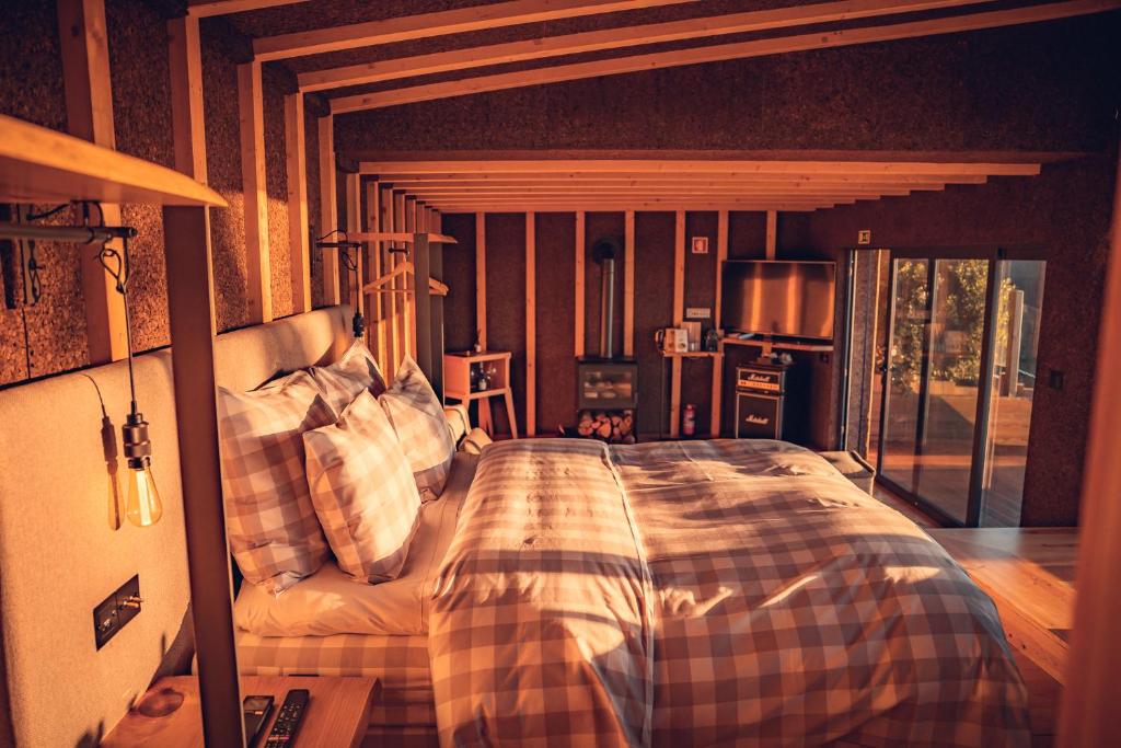 a bedroom with a bed with a checkered blanket at Charm Nature in Azoia