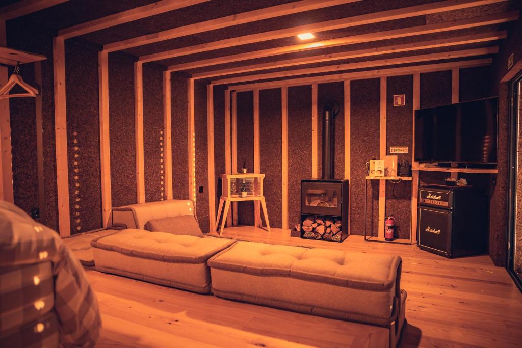 a living room with a couch and a fireplace at Charm Nature in Azoia