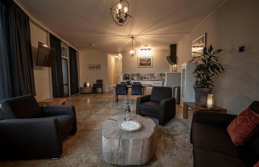 a living room with couches and a coffee table at Brinkzicht Diever, appartement Bert in Diever