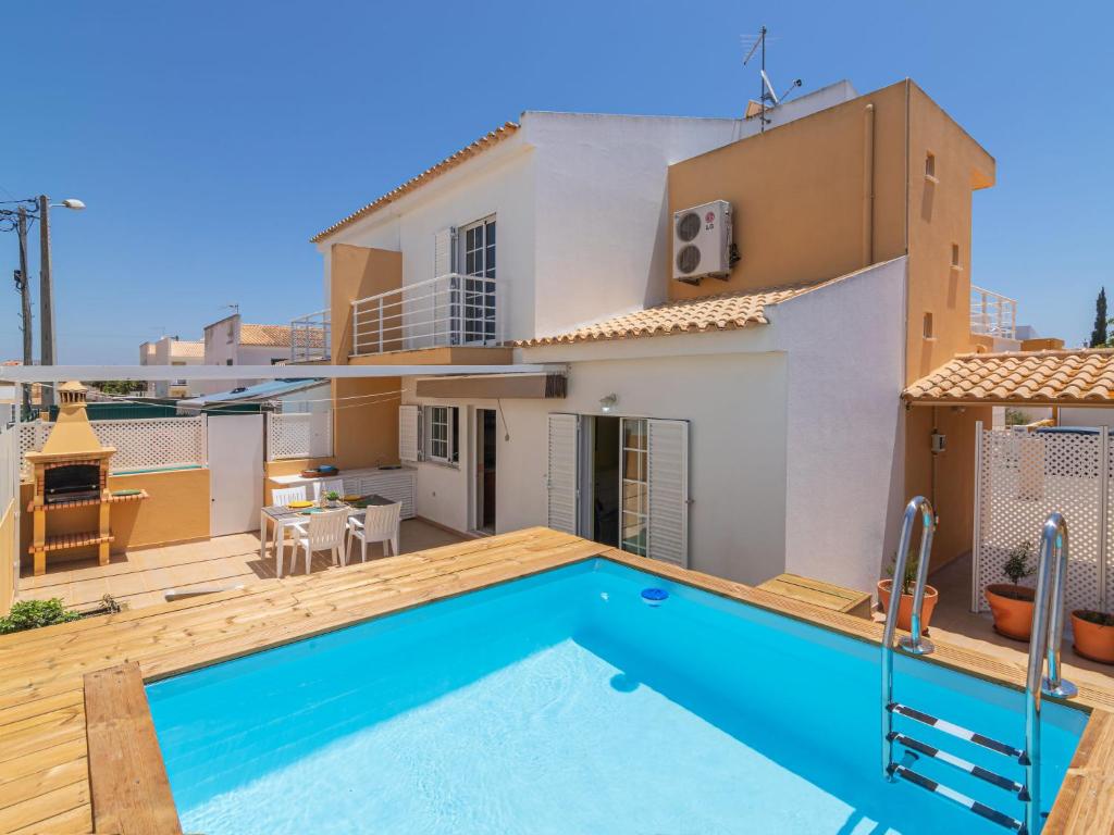 a villa with a swimming pool in front of a house at Holiday Home Sunny Home by Interhome in Pêra