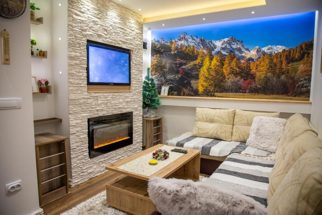 a living room with a couch and a fireplace at SKS in Pale