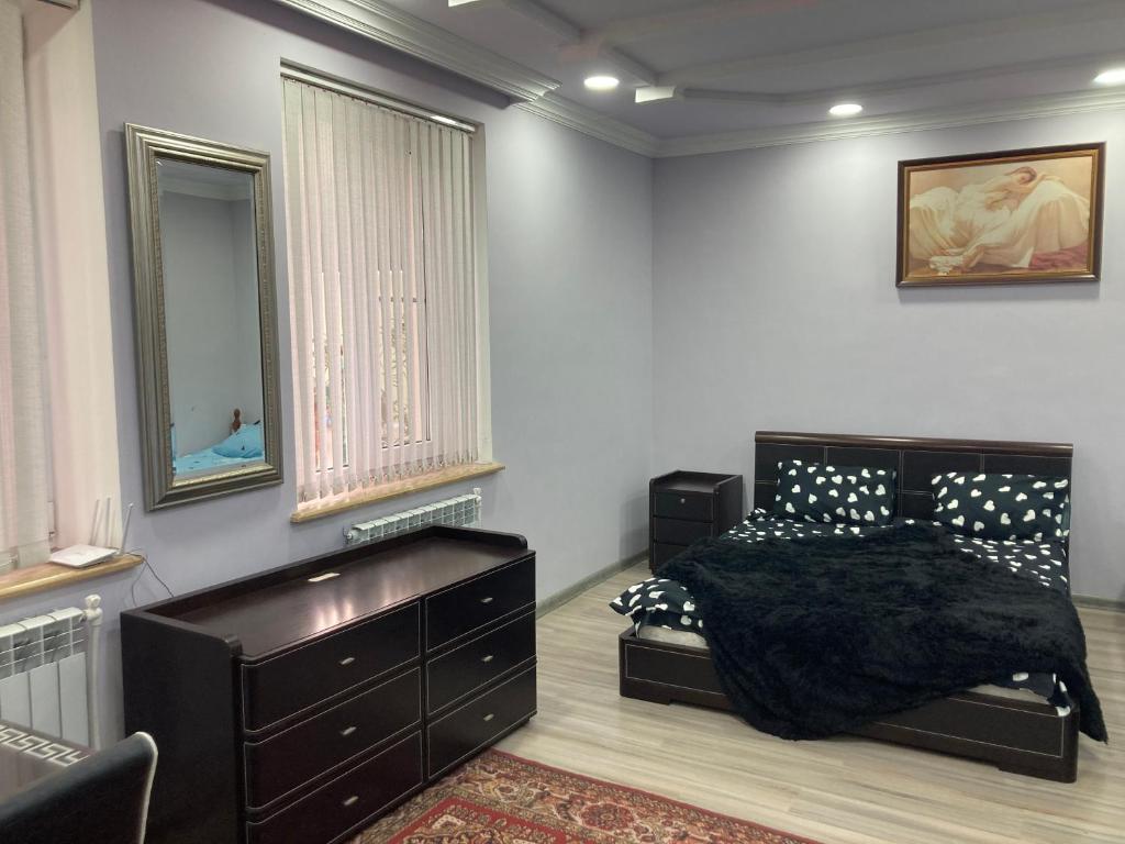 a bedroom with a bed with a dresser and a mirror at GYUMRI VIP in Gyumri