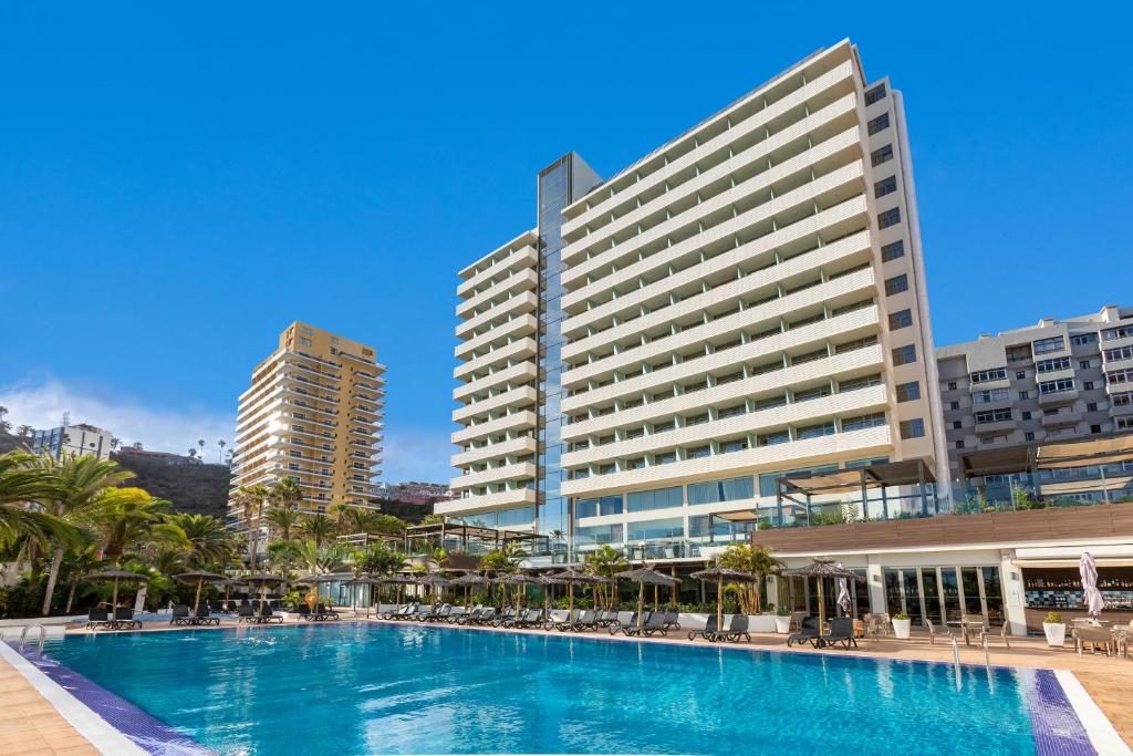 einem Pool vor einem großen Gebäude in der Unterkunft Sol Costa Atlantis Tenerife in Puerto de la Cruz