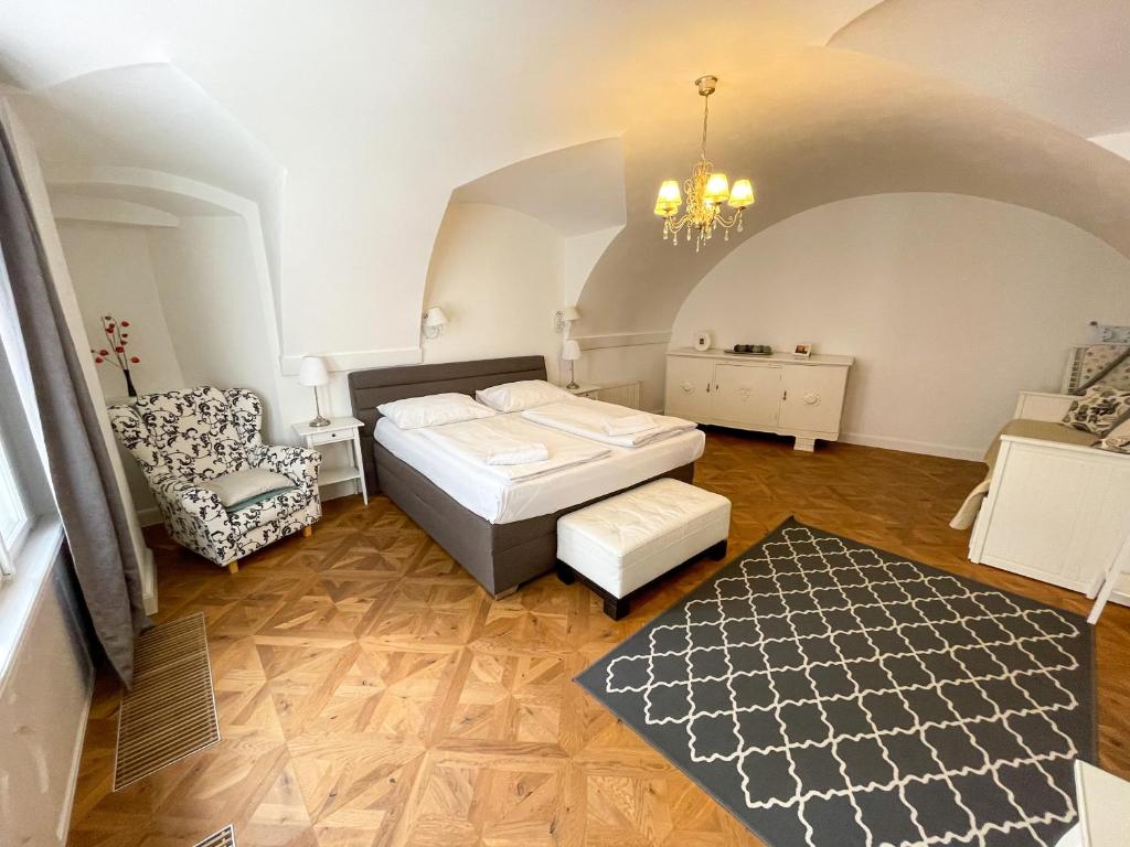 1 dormitorio con 1 cama y 1 silla en una habitación en U Obecního dvora 3 - Old Town Apartment, en Praga